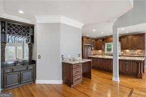 bar featuring baseboards, recessed lighting, and wood finished floors