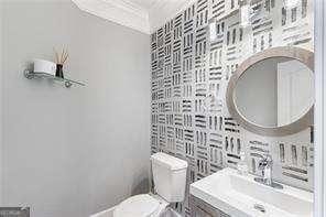 bathroom featuring toilet, vanity, and tile walls