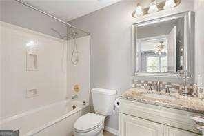 full bath featuring toilet, tub / shower combination, and vanity
