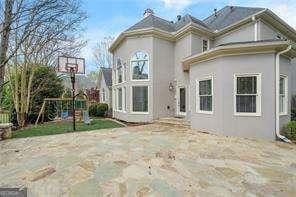 back of property featuring stucco siding