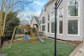 view of jungle gym featuring a lawn