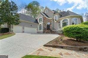 french country style house featuring concrete driveway and an attached garage