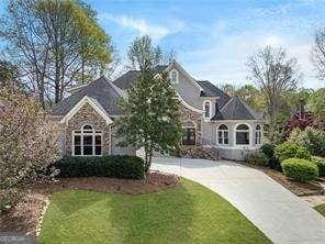 view of front of house featuring driveway and a front lawn