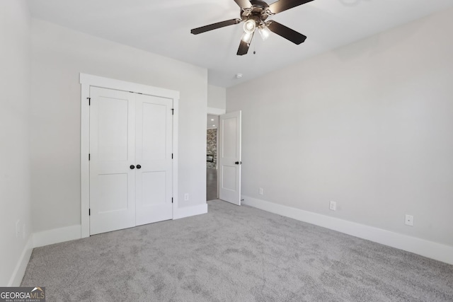 unfurnished bedroom featuring a closet, baseboards, a ceiling fan, and carpet floors