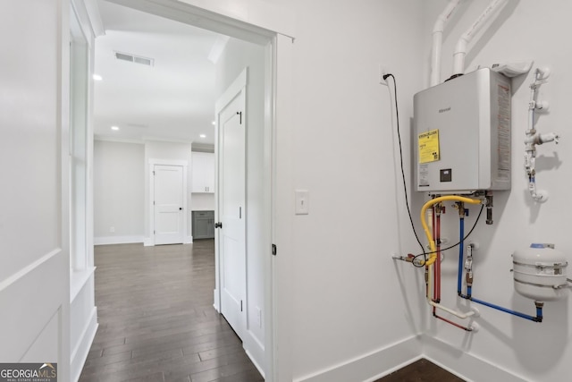 utility room featuring water heater and visible vents