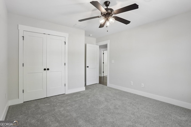 unfurnished bedroom with a closet, baseboards, visible vents, a ceiling fan, and carpet