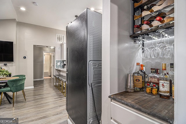 196 Wadley St NW, Atlanta, GA 30314 - kitchen featuring light wood-style floors, white cabinets, freestanding refrigerator, dark countertops, and recessed lighting