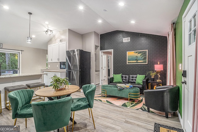 196 Wadley St NW, Atlanta, GA 30314 - dining room with an accent wall, light wood-style floors, vaulted ceiling, recessed lighting, and wallpapered walls