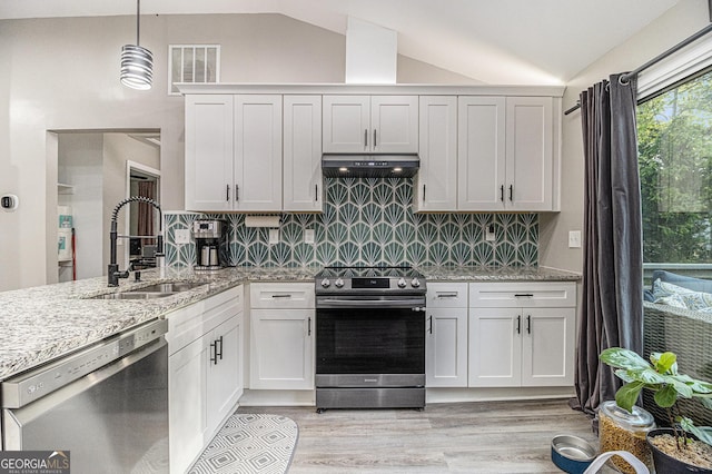 196 Wadley St NW, Atlanta, GA 30314 - kitchen with stainless steel appliances, vaulted ceiling, under cabinet range hood, light wood finished floors, and light stone counters