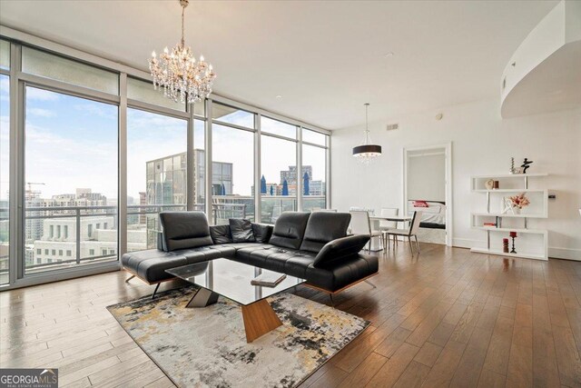 1065 Peachtree St NE Unit 2803, Atlanta, GA 30309 - living room featuring a chandelier, a view of city, and floor to ceiling windows