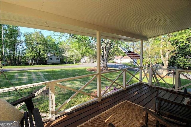 wooden deck with a lawn