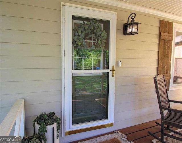 view of exterior entry featuring a porch