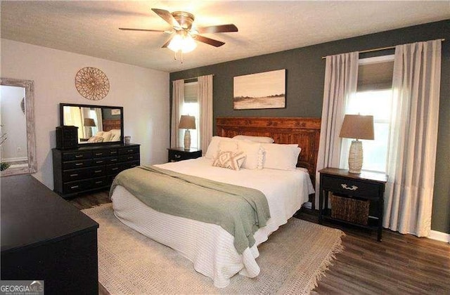bedroom with wood finished floors and a ceiling fan