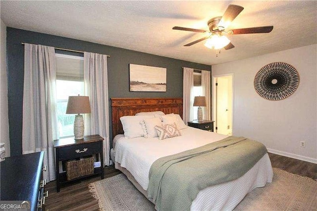 bedroom with dark wood-style floors, baseboards, and a ceiling fan