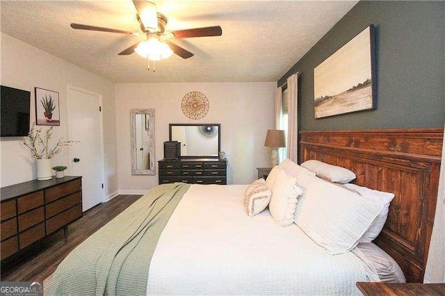 bedroom featuring wood finished floors, a textured ceiling, and ceiling fan
