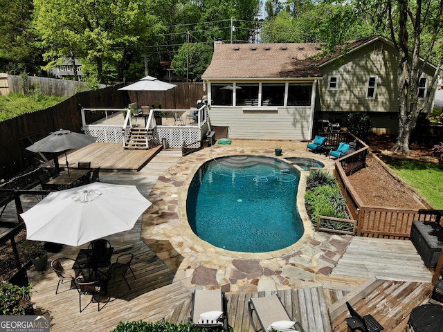 view of pool with a fenced backyard, a fenced in pool, outdoor dining area, and a deck