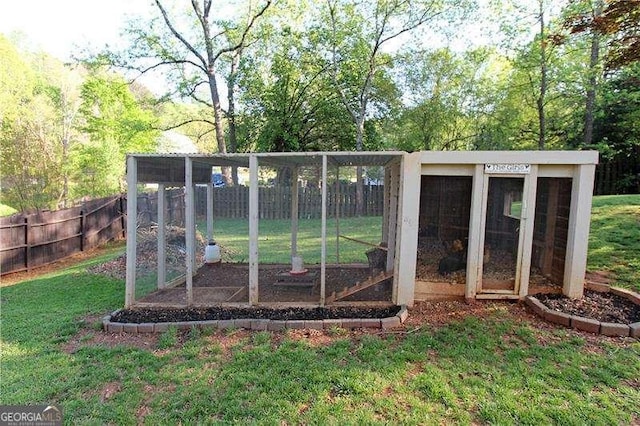 view of poultry coop with fence and a yard