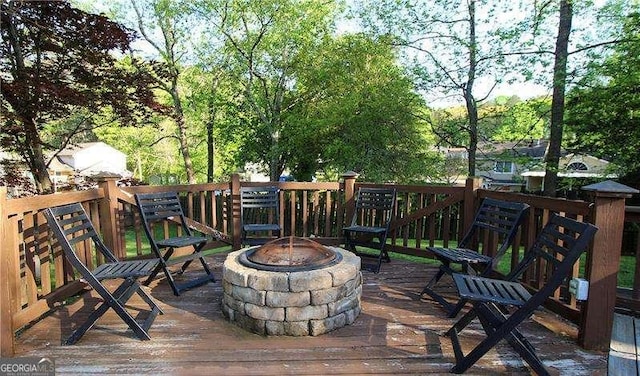 wooden terrace with a fire pit