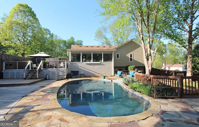 view of swimming pool featuring fence, a wooden deck, a fenced in pool, and a gazebo