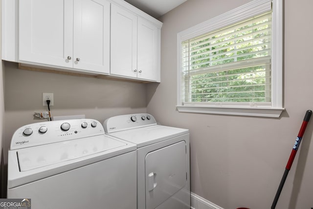 washroom with cabinet space and washing machine and dryer
