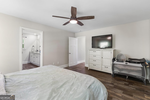 bedroom featuring ceiling fan, baseboards, dark wood finished floors, and ensuite bath