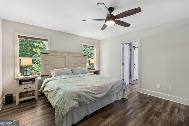 bedroom with ceiling fan, baseboards, and dark wood-type flooring