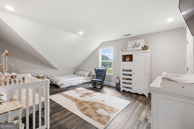 bedroom with vaulted ceiling, visible vents, recessed lighting, and dark wood-style flooring