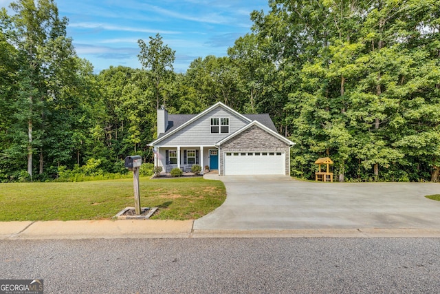 craftsman-style home featuring concrete driveway, a chimney, a front lawn, an attached garage, and a porch