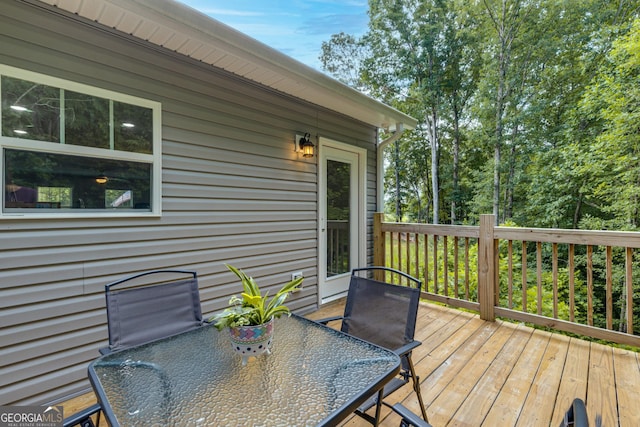 wooden terrace with outdoor dining space