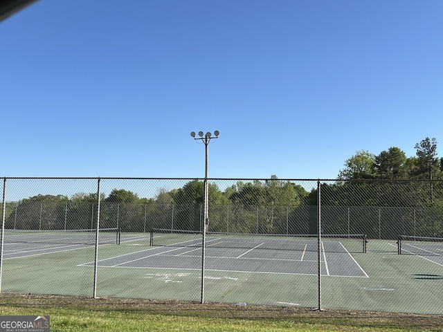 view of sport court with fence