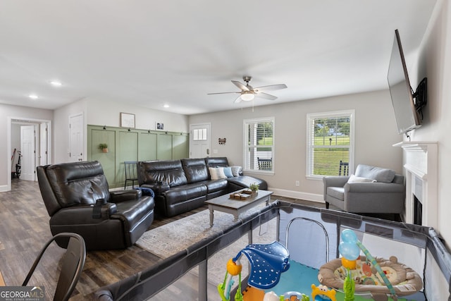 living area with recessed lighting, wood finished floors, a ceiling fan, and baseboards