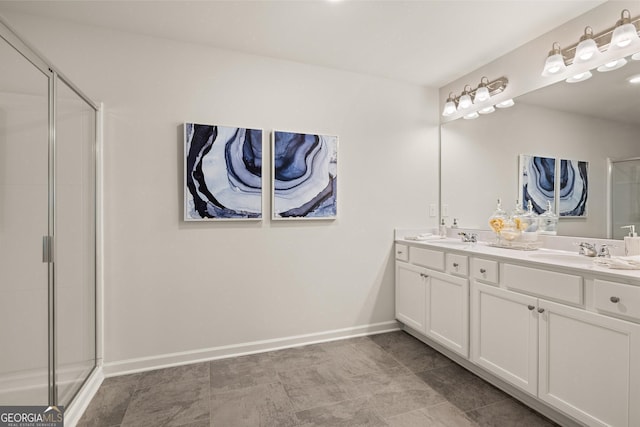 38 Buckingham Ln Unit 232, Hoschton, GA 30548 - bathroom with a stall shower, double vanity, a sink, and baseboards