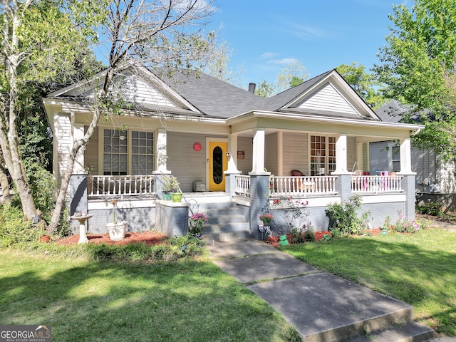 bungalow-style home featuring a porch and a front lawn