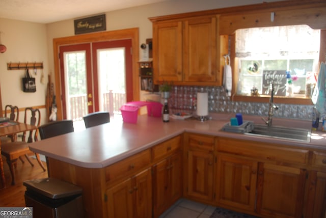 249 Spruce Creek Rd, Lakemont, GA 30552 - kitchen featuring brown cabinetry, a sink, light countertops, a peninsula, and french doors