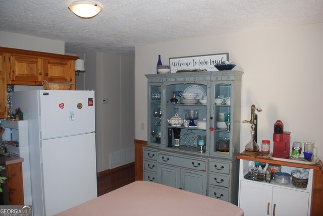 249 Spruce Creek Rd, Lakemont, GA 30552 - kitchen featuring freestanding refrigerator and a textured ceiling