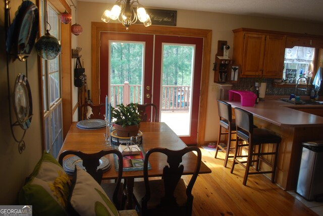 249 Spruce Creek Rd, Lakemont, GA 30552 - dining area featuring a chandelier, healthy amount of natural light, light wood-style flooring, and french doors