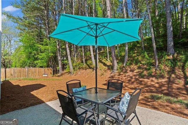 view of patio / terrace featuring outdoor dining area and fence