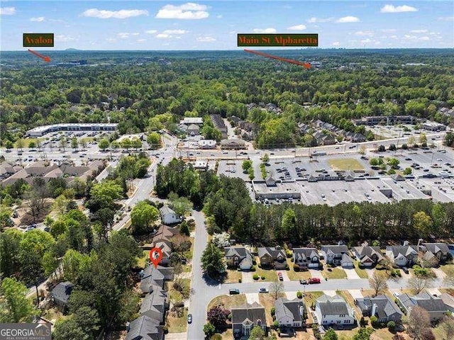 birds eye view of property with a wooded view and a residential view