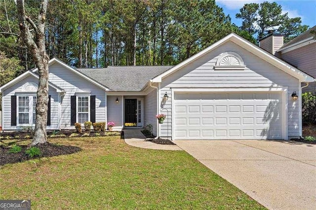 ranch-style home featuring a front yard, an attached garage, and driveway