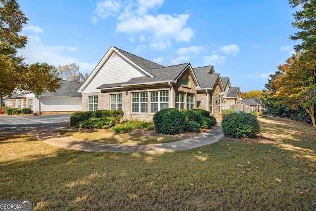 4573 Caleb Xing Unit 20, Powder Springs, GA 30127 - view of home's exterior featuring a yard and brick siding