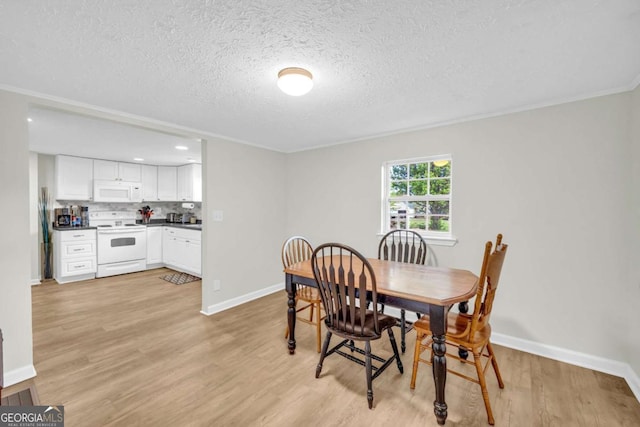 7310 Pea Ridge Pl, Gainesville, GA 30506 - dining area featuring baseboards, light wood-type flooring, and a textured ceiling