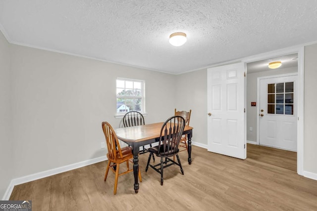7310 Pea Ridge Pl, Gainesville, GA 30506 - dining area featuring baseboards, light wood-style floors, and a textured ceiling
