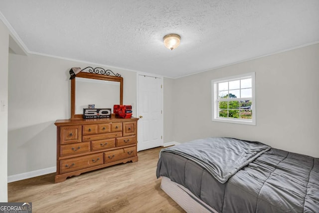 7310 Pea Ridge Pl, Gainesville, GA 30506 - bedroom with crown molding, light wood-style floors, baseboards, and a textured ceiling
