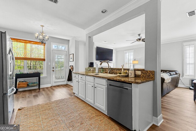 kitchen featuring crown molding, appliances with stainless steel finishes, visible vents, and white cabinets