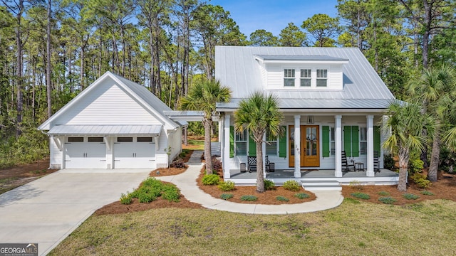105 Whispering Oaks Ln, Saint Marys, GA 31558 - view of front of house with french doors, a porch, a garage, and a front lawn
