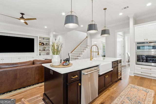 105 Whispering Oaks Ln, Saint Marys, GA 31558 - kitchen with visible vents, a sink, ceiling fan, appliances with stainless steel finishes, and crown molding