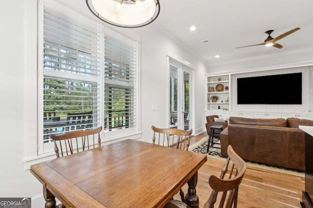105 Whispering Oaks Ln, Saint Marys, GA 31558 - dining room featuring ornamental molding, ceiling fan, wood finished floors, and built in shelves