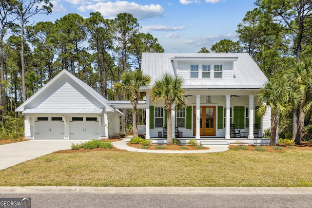 105 Whispering Oaks Ln, Saint Marys, GA 31558 - modern farmhouse style home featuring a porch, a front lawn, an attached garage, french doors, and driveway