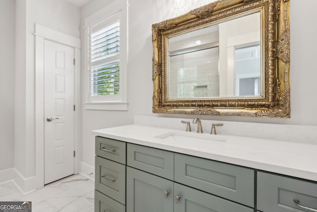 105 Whispering Oaks Ln, Saint Marys, GA 31558 - bathroom with baseboards, marble finish floor, vanity, and a shower with door