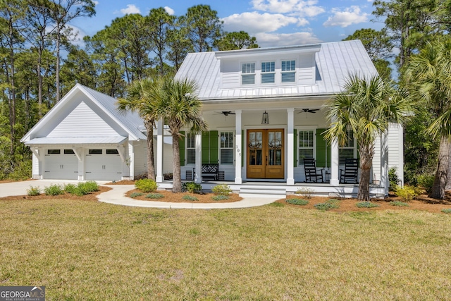 105 Whispering Oaks Ln, Saint Marys, GA 31558 - modern farmhouse with concrete driveway, french doors, a ceiling fan, a front lawn, and a garage